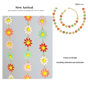 Detailed close-up of colorful enamel daisy necklace and bracelet set with gold plating