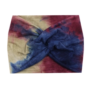 Detail of bohemian wide headband with dark blue and red tie-dye print and center knot