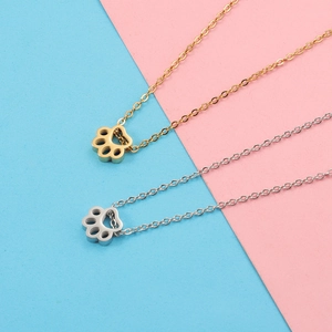 Gold and silver stainless steel necklaces with cute animal paw pendants on split background