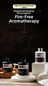 Detailed macro of 120ml aromatherapy diffuser bottles with black fiber sticks on a tray