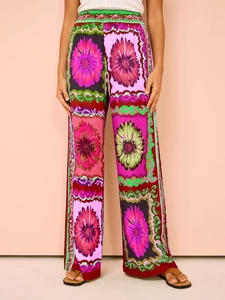 Detail of floral wide-leg pants with elastic high waist and colorful geometric patterns