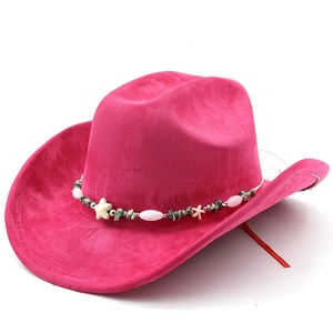 Detail view of pink suede cowboy hat featuring bohemian beaded band and star accents