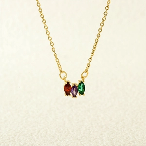 Detail of gold necklace featuring vertical marquise-cut red, purple, and green gemstones