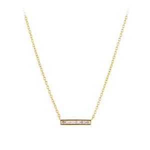 Detail of a minimalist gold pendant necklace featuring four square-cut clear zircons