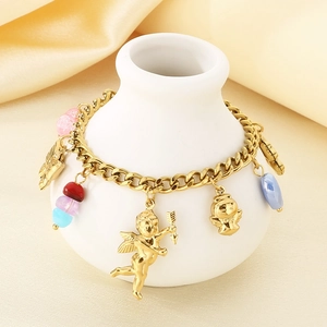 Detail of gold angel pendants and colorful beads on a bracelet over champagne silk