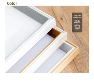 Detail of wooden picture frames in blue gray, walnut and white wood grain finishes