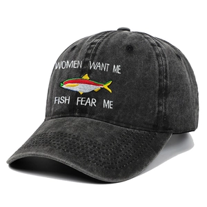 Detailed embroidery of fish and text on washed black vintage cotton fishing cap