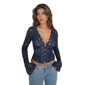 Detailed close-up of dark blue lace blouse featuring V-neck and ruffled flare sleeves
