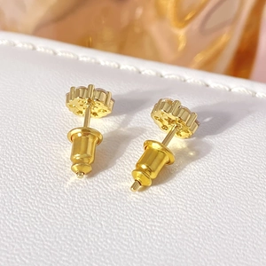 Macro shot showing the intricate back structural detail and golden plating of the flower earring