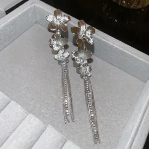 Silver flower tassel earrings with sparkling rhinestones and long drop design