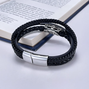 Detailed close-up of multi-layer black leather woven bracelet with silver magnetic clasp