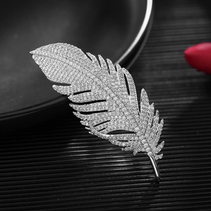 Sparkling zircon-encrusted feather brooch in silver finish for elegant suits and dresses