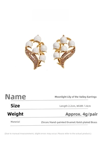 Detailed view of lily of the valley earrings with white enamel and golden stems