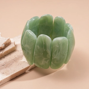 Detail of green marbled acrylic stretch bracelet with polished rectangular resin links