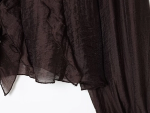 Detailed macro view of dark brown pleated fabric texture with premium stitching details