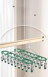 Detail of green heavy-duty drying rack with 20 stainless steel clips and windproof hook