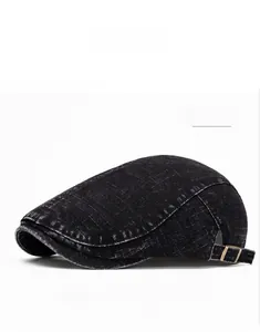 Detail of washed black denim ivy cap showing fabric texture and adjustable metal buckle