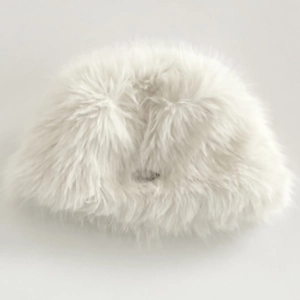 Close-up of soft white faux fur texture on a warm winter bucket hat for women