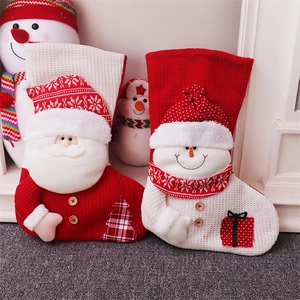 Large knitted Christmas stockings featuring 3D Santa and Snowman designs for gift storage