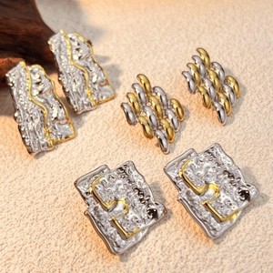 Vintage style gold and silver pleated stud earrings set with metallic woven texture