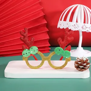 Christmas reindeer glasses with gold glitter frames, red antlers, and green bow tie