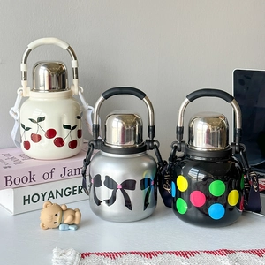 Close-up of 316 stainless steel vacuum flasks with cherry, bow, and polka dot patterns