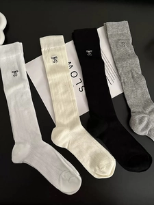 Close-up of four colors of cotton calf socks featuring delicate bow embroidery detail