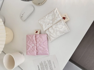 Detailed top view of pink and white heart-quilted sanitary pouches with snap buttons