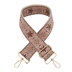 Close-up of ethnic embroidered shoulder strap with floral patterns and alloy metal buckles