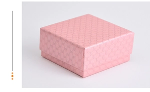 Detailed view of square pink jewelry gift box with elegant diamond texture pattern