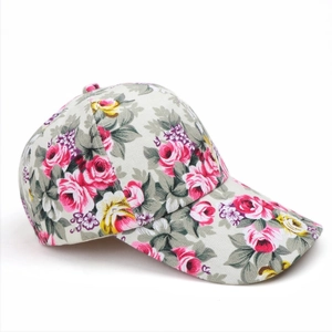 Detail of floral baseball cap with pink and yellow roses on breathable canvas fabric