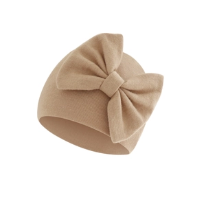 Detail of soft khaki knit baby beanie featuring a large decorative knit bow on front
