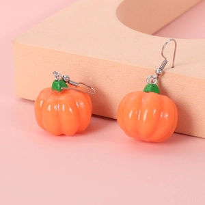 Detail of cute Halloween pumpkin drop earrings with orange resin and silver hooks