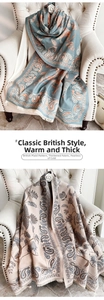 Detail of blue and beige paisley cashmere-like scarves with fringe on a stylish sofa