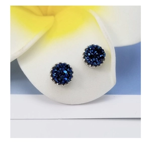 Close-up of S925 sterling silver stud earrings with deep blue druzy crystals on white petals
