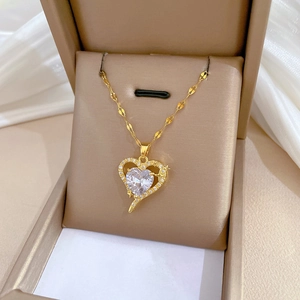 Luxurious gold heart pendant necklace with zircon crystals in a beige jewelry gift box