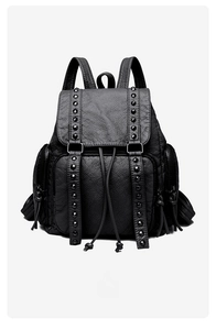 Detailed view of black washed faux leather backpack with studs and drawstring closure