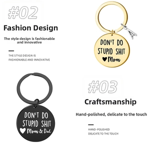 Detailed view of polished stainless steel keychains in gold and black with engraved quote