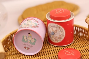 Detail of round tin canisters with Rabbit wedding and Alice in Wonderland illustrations