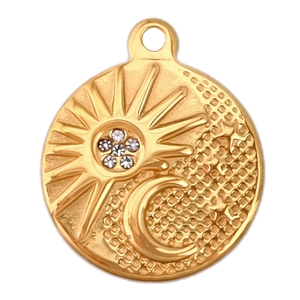 Macro view of gold sun and crescent moon pendant with micro-pave white zircon stones