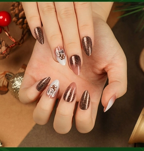 Close-up of brown glitter Christmas press-on nails with 3D gold flowers and gradient finish