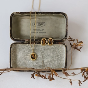 Artistic detail of vintage tiger eye jewelry set with necklace and stud earrings