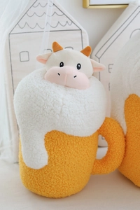 Macro shot of fluffy cow head plush in beer mug shape with realistic faux fur texture