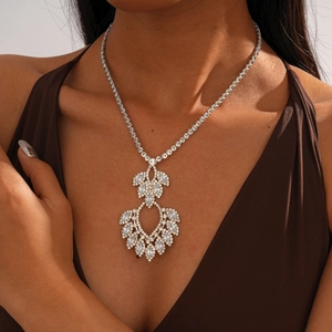 Detail of a luxury drop-shaped crystal necklace on a model for high-end fashion styling