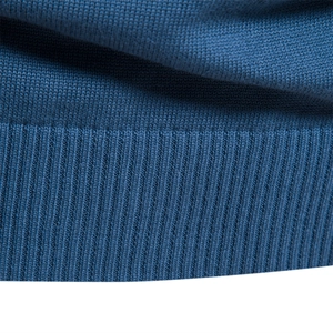 Close-up of the ribbed cuff and knit texture on this navy blue men's pullover sweater