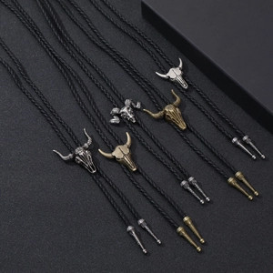 Retro bull head bolo ties with braided black leather cords in silver and bronze finishes