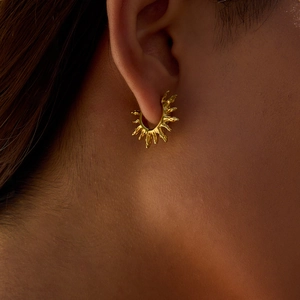 18K gold plated stainless steel sunburst hoop earrings for women on a model