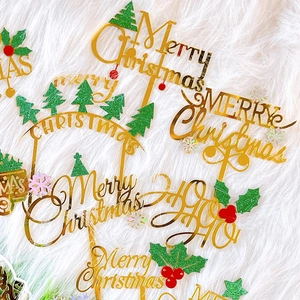 Golden acrylic Merry Christmas cake toppers set on white plush background
