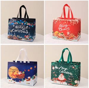 Detailed close-up of four festive non-woven Christmas gift bags with colorful holiday patterns