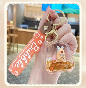 Detail of creative orange backpack liquid keychain with drifting glitters and cute bunny